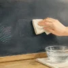 黒板のポスカを布で優しく拭く様子